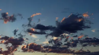 Colorful evening sky. Cumulus clouds sweep across the sky at sunset. Accelerated video