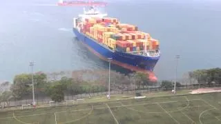 Container ship sails straight to shore by university football field