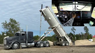 Hauling fine sand with the end dump. Cockpit view grabbin gears