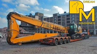 Caterpillar 349E loading brandnew high reach demolition excavator on overzize load transport