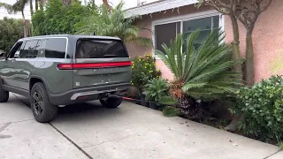 Rivian R1S pulling out unwanted tree.
