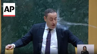 WATCH: Georgian opposition lawmaker doused with water during parliament speech