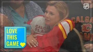 Selfless young fan hands a puck to an appreciative girl