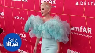 Katy Perry rocks feathers on her gown arriving at the amFar Gala