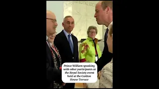Prince William speaking with other participants at the Royal Society event