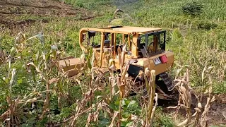 CAT D6R XL Bulldozer working at the foot of a mountain is very risky