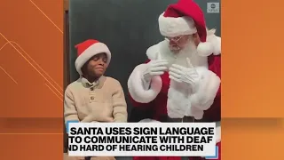 Santa Claus uses sign language with kids that are hard of hearing