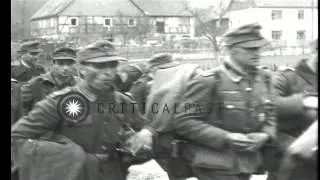 US Army soldiers guard group of German POWs; dead German soldiers near Westenfeld...HD Stock Footage