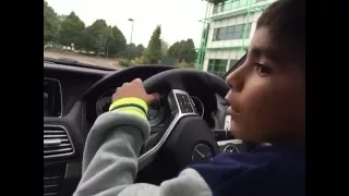 Kid driving Mercedes E coupe