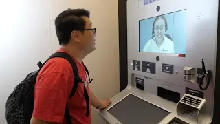 mrbrown tries out the Video Teller Machine by DBS/POSB