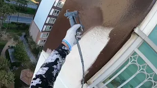 Airless sprayer. Exterior wall painting process.