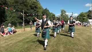 Drum Major leads Newtonhill Pipe Band playing Green Hills on the march at 2023 Drumtochty Games