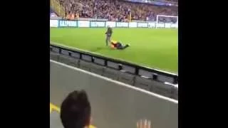 A steward at the Man United try to catch a pitch invader