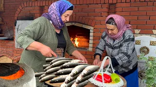 SINGLE FAMILY AT THE TOP OF THE MOUNTAIN. SHE COOKED FISH WITH VEGETABLES IN THE OVEN