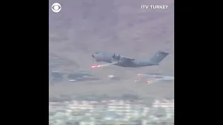 Military plane dispenses flares as it takes off of Kabul Airport (Afghanistan)