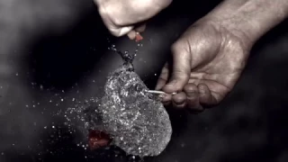 Water balloon bursts in slow motion