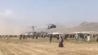 US Army Apache Helicopter Clearing People Off Afghanistan Runway So C-17 Airplane Can Takeoff