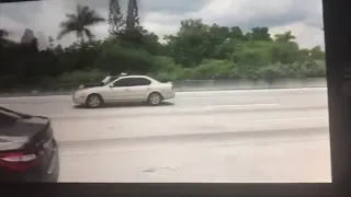 Video shows man clinging to outside of car as it speeds down I-95