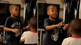 Big brother helps little brother calm down with breathing exercise