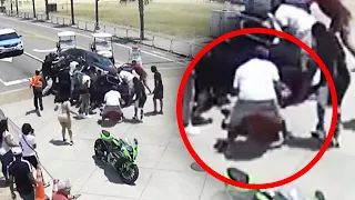 Bystanders and Police Lift Car Off Trapped Motorcyclist