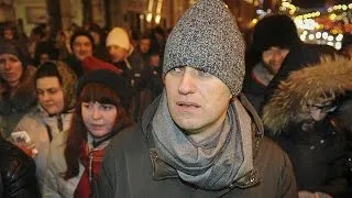 Hours after fraud conviction, Navalny detained by police for attending anti-Kremlin protest