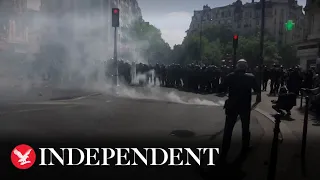 Police use tear gas during annual May Day rally in Paris a week after Macron's election