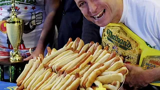 Defending champ sets new record eating 74 hot dogs in 10 minutes