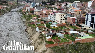 Torrential rains batter Bolivia with homes teetering on the edge of collapse
