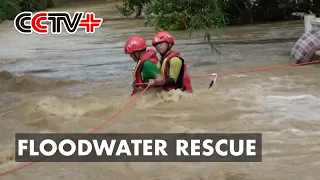 Firefighters Rescue Two People Stranded in Floodwater in South China