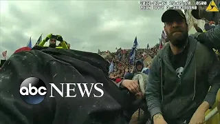 Capitol Police officer Michael Fanone reacts to footage of rioters attacking him