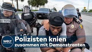 NIEDERKNIEN GEGEN RASSISMUS: Polizisten in Solidarität mit Demonstranten