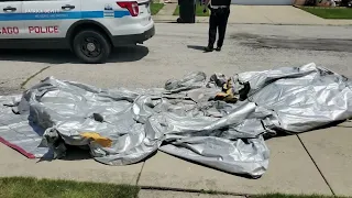 BREAKING: Emergency slide falls from plane, lands in backyard near Chicago airport, police say