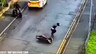 Video captures moment thug falls off scooter after trying to kick police car