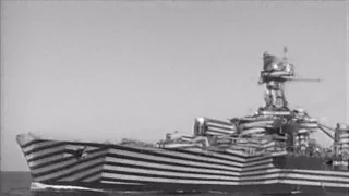 French cruiser "Gloire" in dazzle camouflage firing guns - 1944