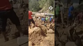 Villagers march with shovels to clean up landslide-hit areas of Papua New Guinea