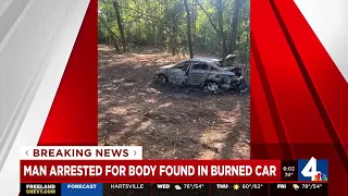 Man arrested for body found in burned car