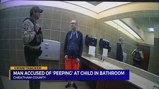 Man accused of 'peeping' at child in bathroom