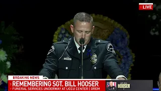 Lt. Mike Wall from the Santaquin, Utah Police Department speaks at Sgt. Bill Hooser's funeral