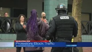 Protesters march outside Portland Building during City Council meeting