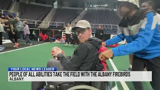 Adults and children with disabilities play with Albany Firebirds