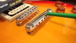 Why top wrap strings on Les Paul and SG tailpieces?