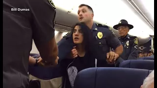 REMOVED FROM FLIGHT: A woman is forcibly removed from a Southwest flight by police