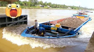 The cargo barge is overloaded trying to cross dangerous fast water