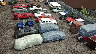 Model railroad update. It started out as a 1/87 junkyard and morphed into a 1/64 scale garage.