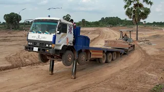 Trailer trucks transportation Bulldozers and Heavy trucks unloading dirt with Dozer pushing dirt