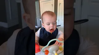 Baby eating carrots for the first time