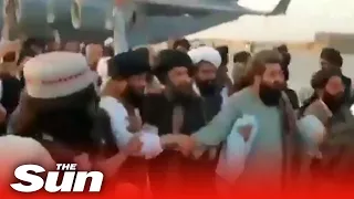 People cheer as Taliban leader Mullah Baradar returns to Afghanistan after 10 years