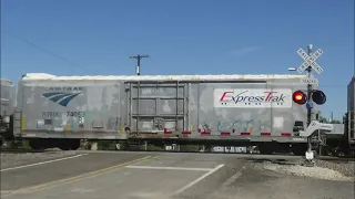 BNSF intermodal with AMTRAK boxcars sitting in rogers Texas W/BNSF redworm grain train