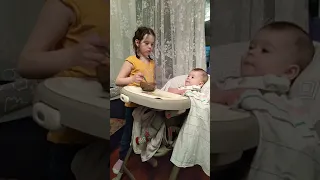 Сестрёнка кормит братика
