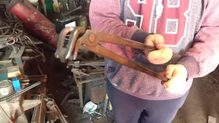A tongs i forged for holding railway spikes by finín Liam Christie blacksmith from Ireland